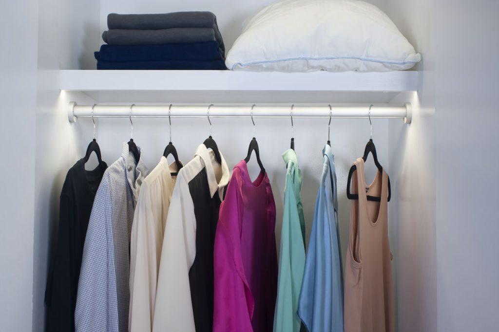 Clothes Hanging In Closet With Led Lighting Built In