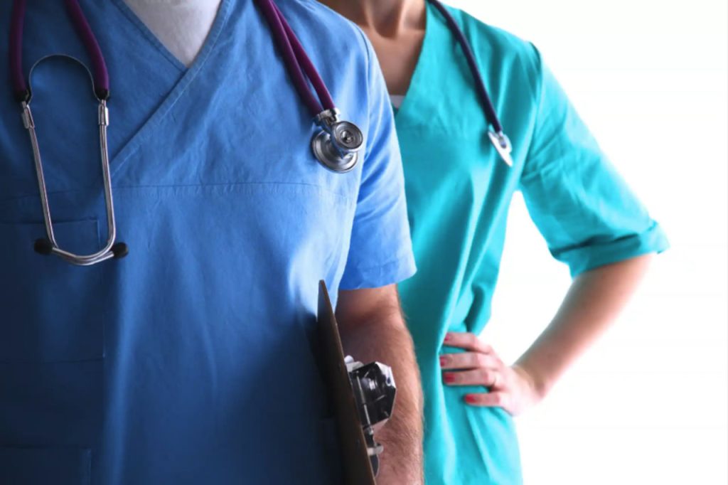 Nurdes Wearing Scrubs Carrying Stethoscopes And Clipboard