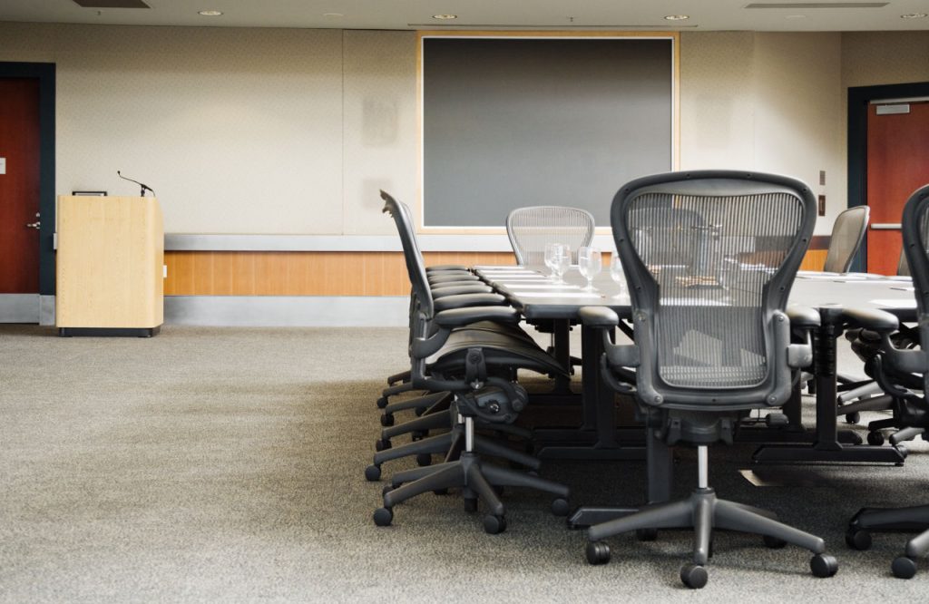 University Lecture Room With Table And Rolling Chairs